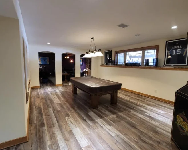 basement with wooden floor and billard table at the middle