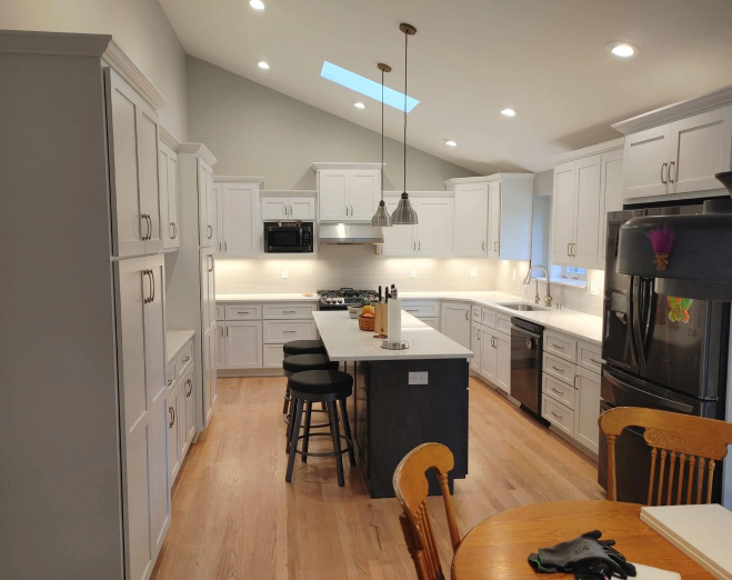 new modern kitchen with bright lighting and white cabinets and countertops